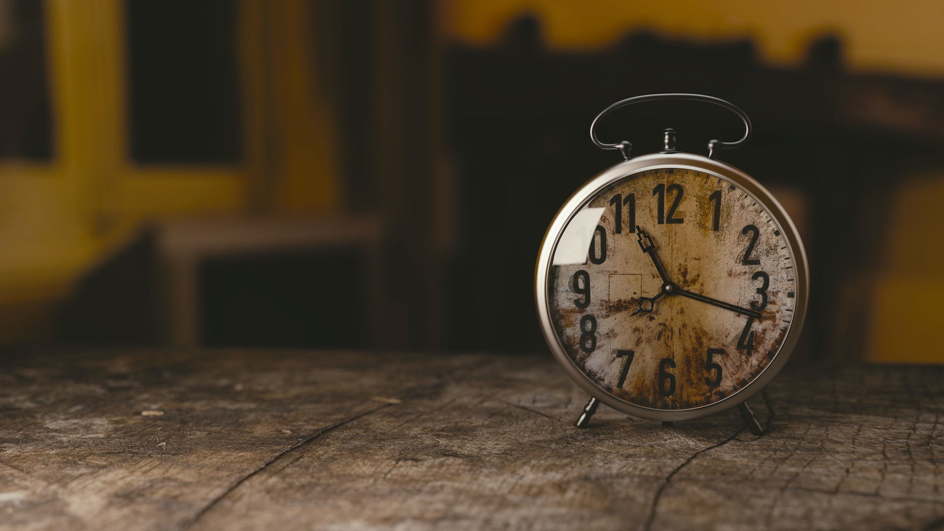 selective focus photography gray analog clock on black surface